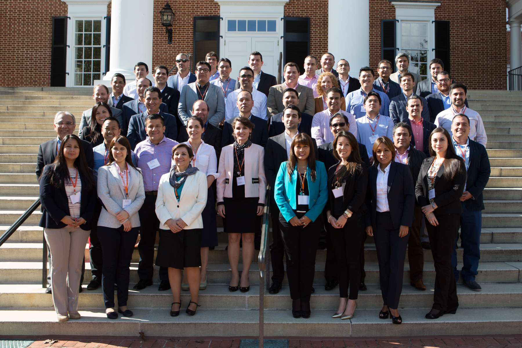 Visiting students from PAD's Executive MBA program stand on Darden's Saunders Steps at the end of their second day of the program at Darden. 