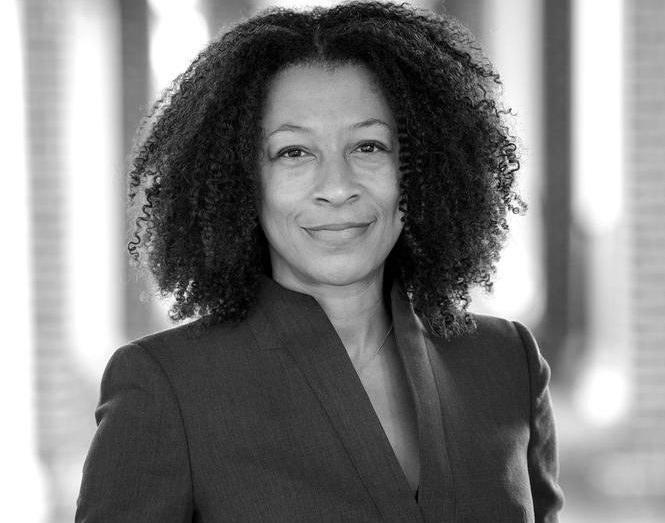 A black and white picture featuring Professor Toni Irving in a black suit