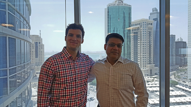 Stan and Sachin Misra (MBA '09)  connect in Exxon Mobil's Doha office. 